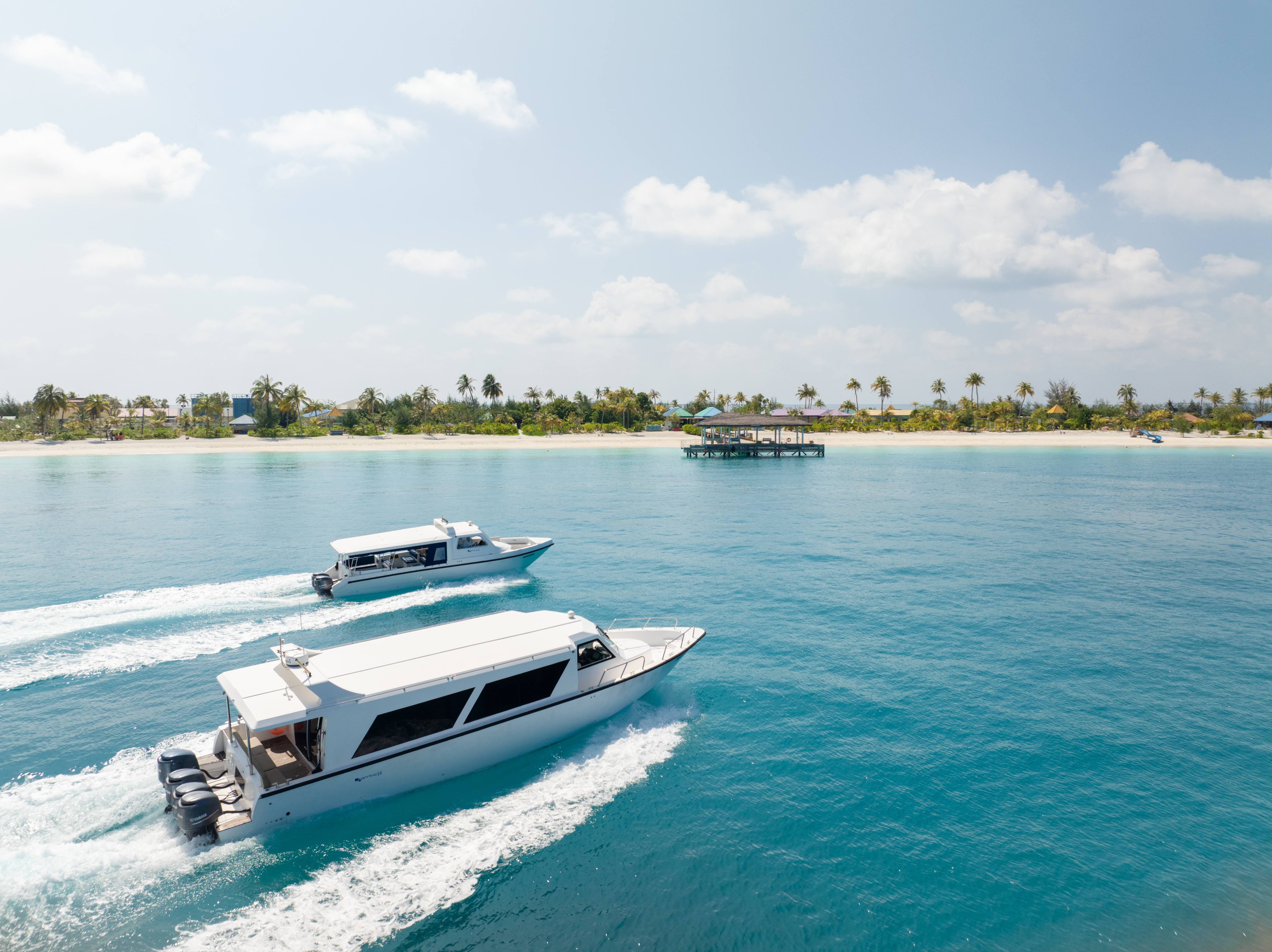 Private speed boat transfers approaching a beautiful Maldives island.